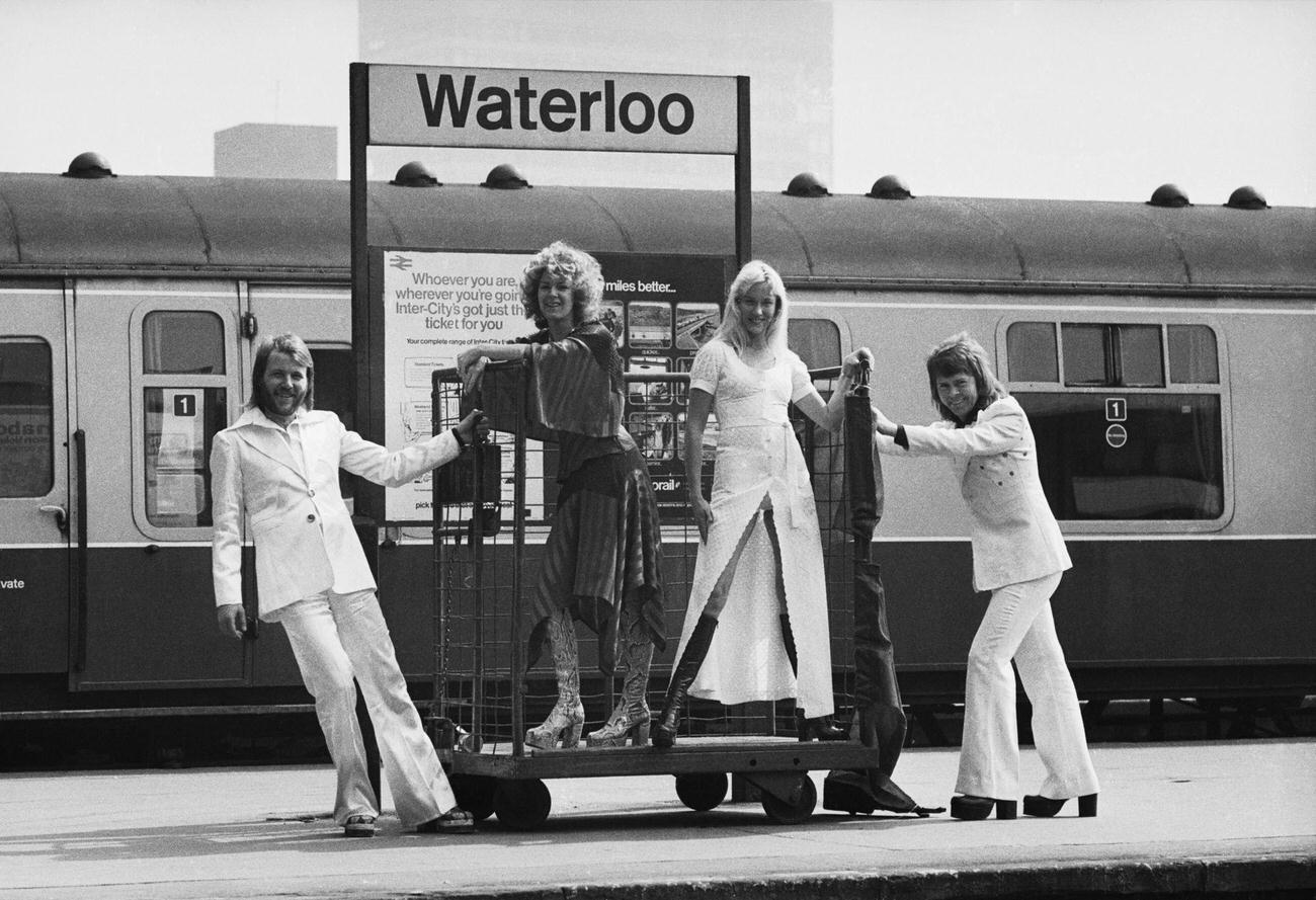 Benny Andersson, Anni-Frid Lyngstad, Agnetha Faltskog and Bjorn Ulvaeus of the Swedish pop group ABBA posing at Waterloo railway station, 1974
