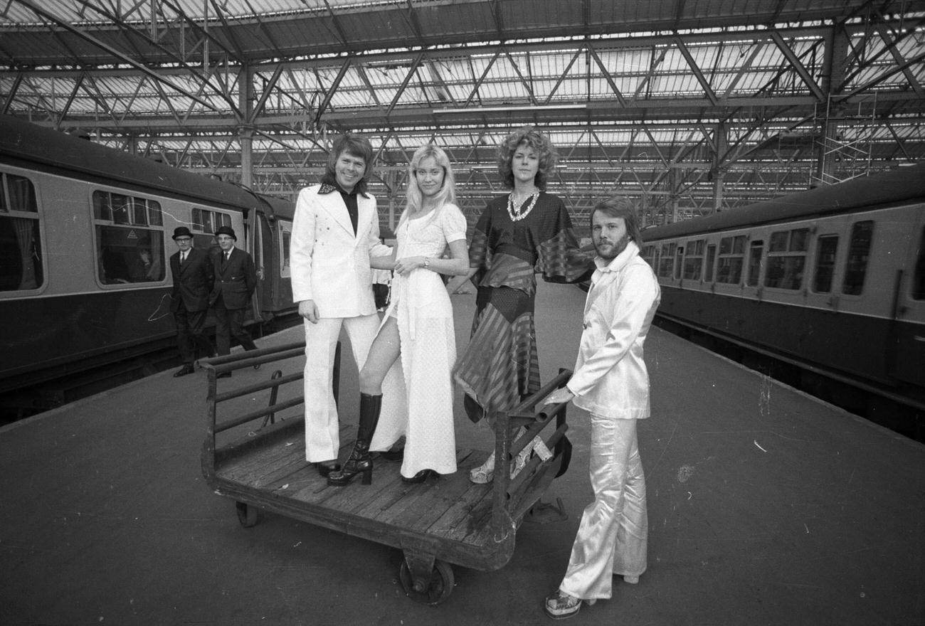 Benny Andersson, Anni-Frid Lyngstad, Agnetha Faltskog and Bjorn Ulvaeus of the Swedish pop group ABBA posing at Waterloo railway station, 1974