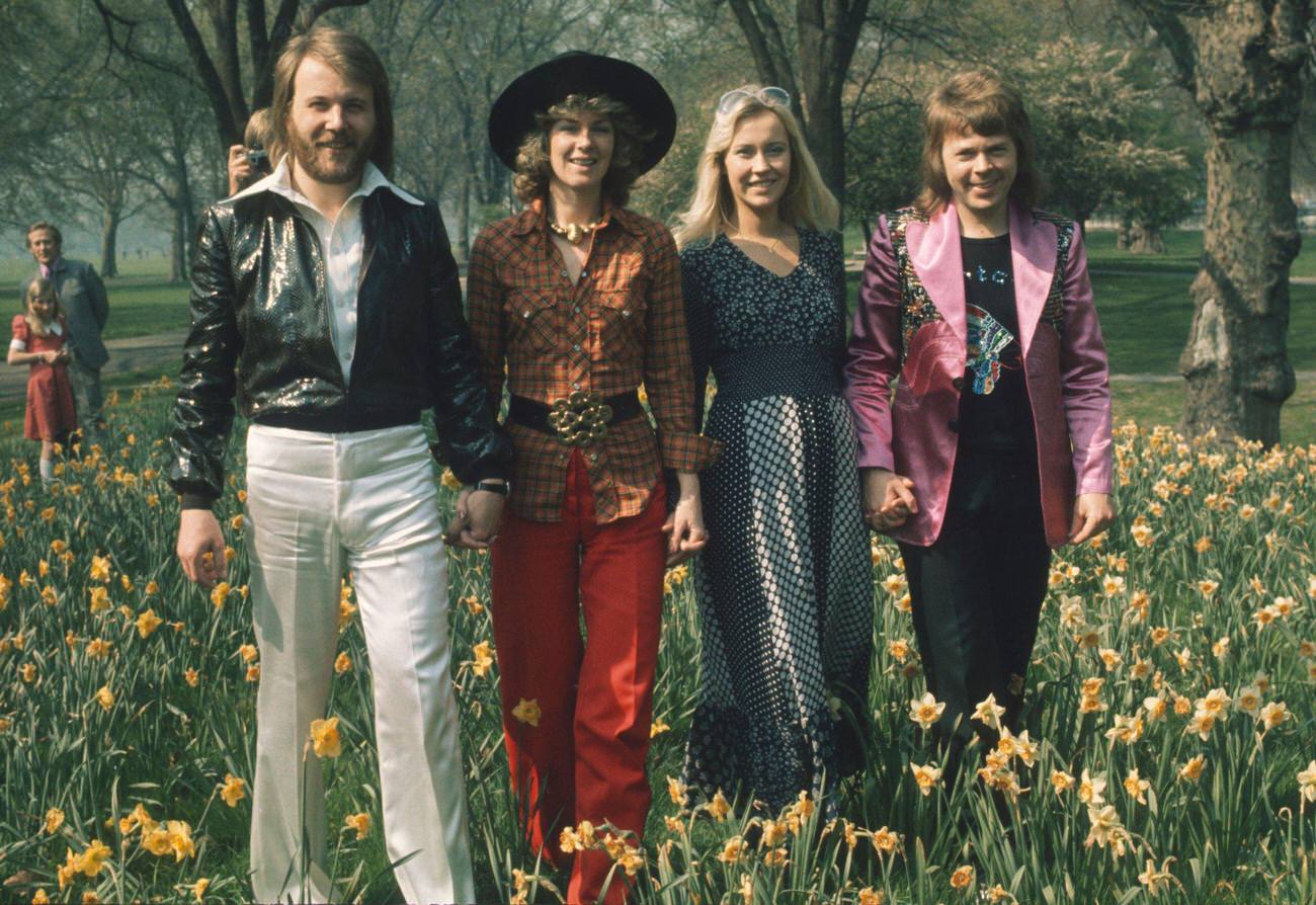 Swedish pop group Abba at Brighton, strolling hand in hand amongst the daffodils in Hyde Park on April 09, 1974