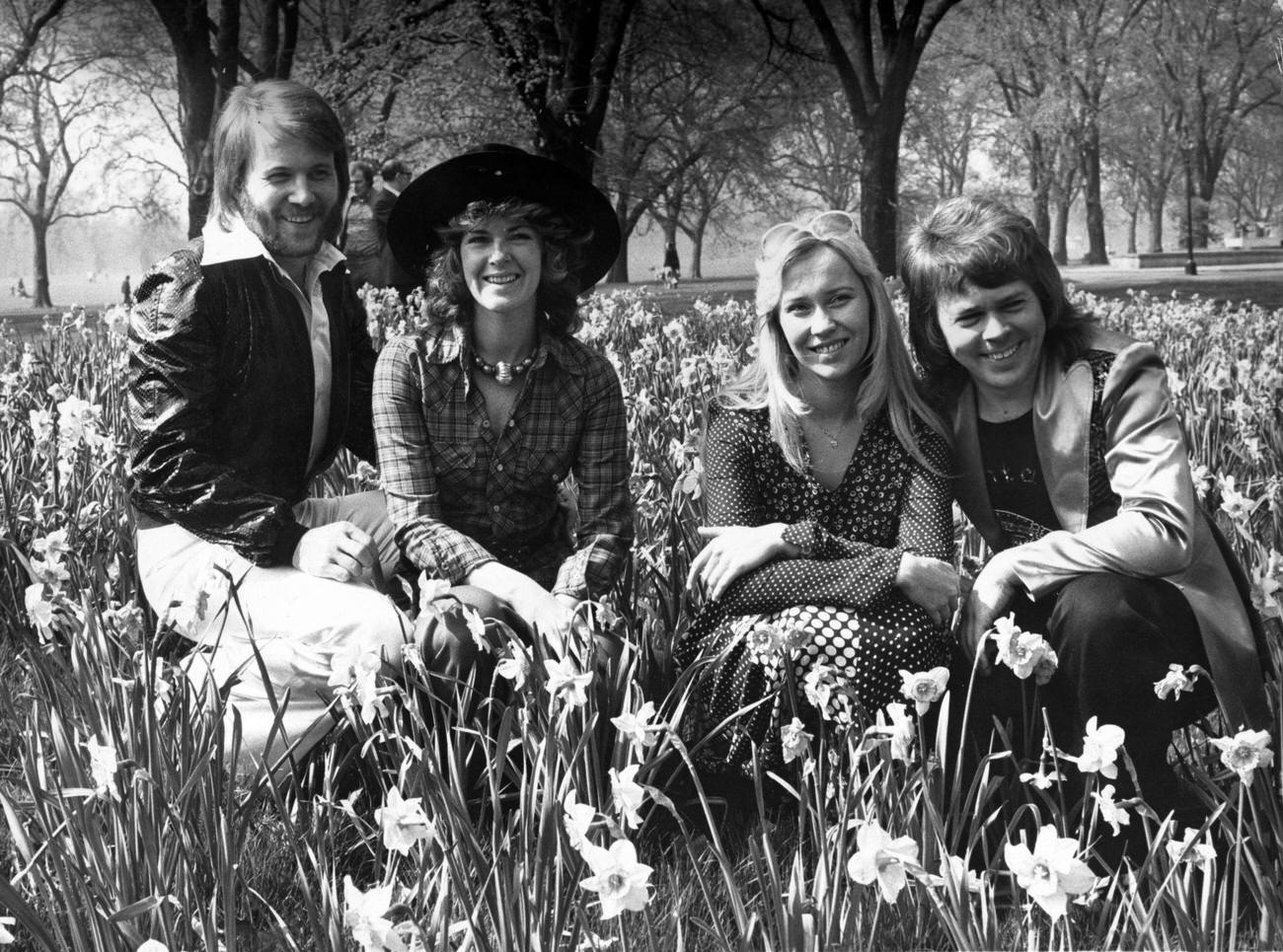 Benny Andersson, Anni-Frid Lyngstad, Agnetha Faltskog and Bjorn Ulvaeus, sitting amongst the daffodils in London