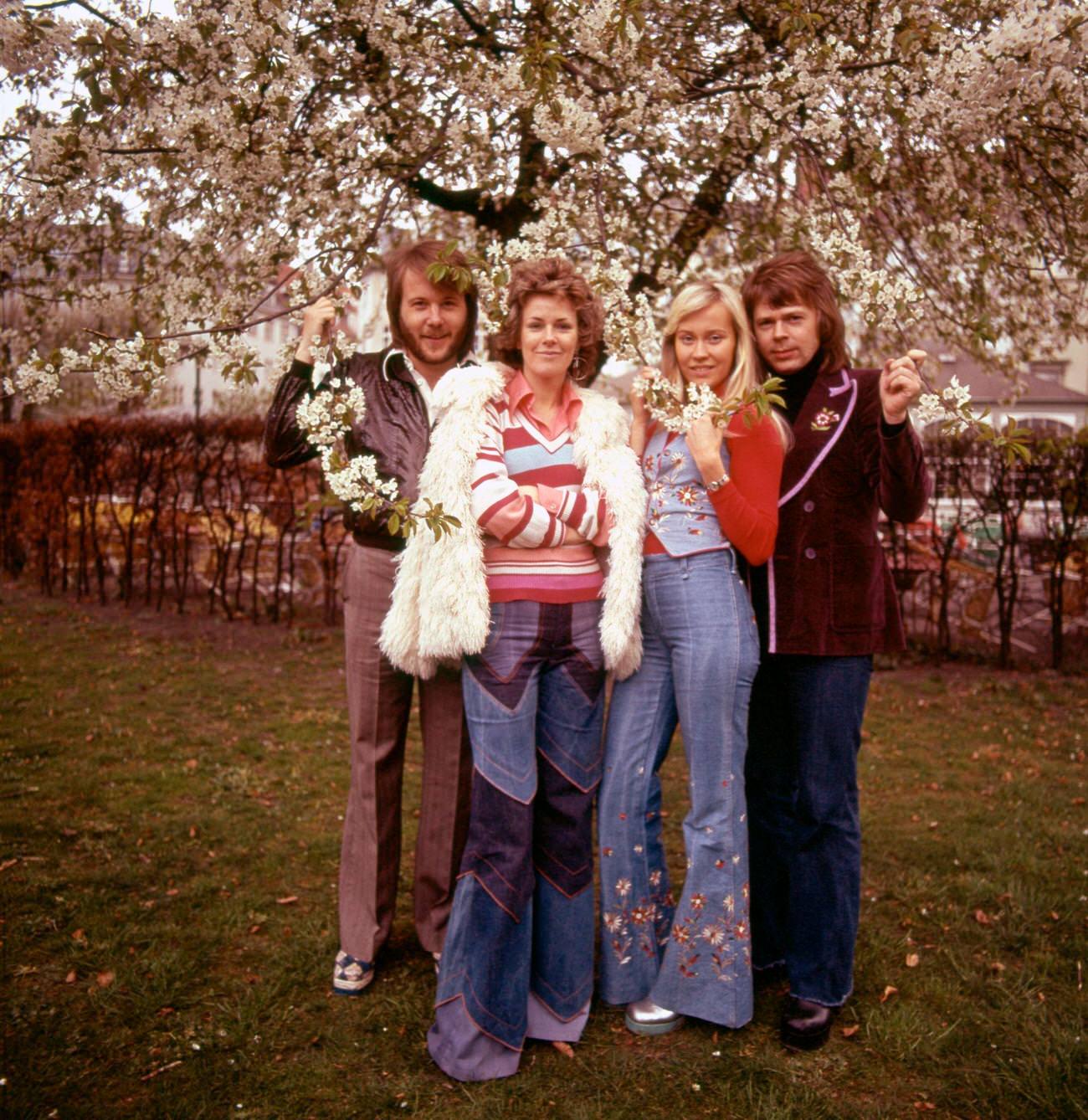 Benny Andersson, Anni-Frid Lyngstad, Agnetha Faltskog and Bjorn Ulvaeus of Swedish pop group ABBA pose for a group portrait in a garden in Copenhagen, Denmark in April 1974.