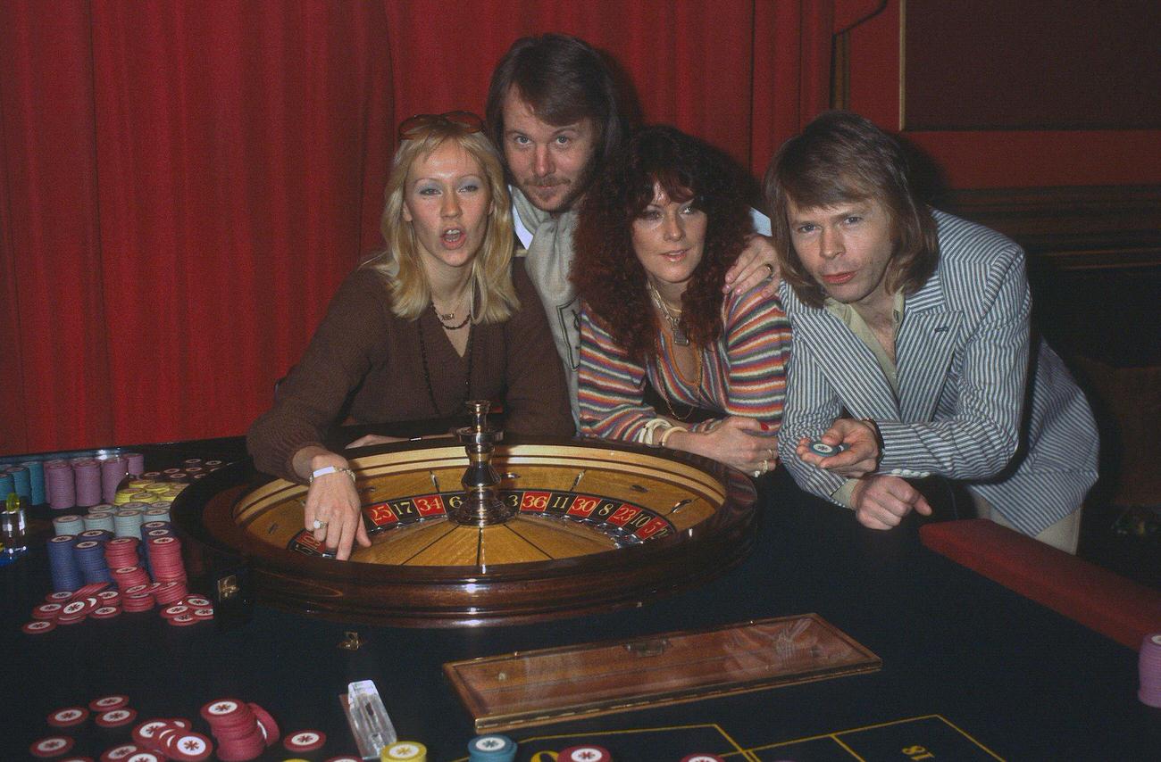 Abba (L-R) Agnetha Faltskog, Benny Andersson, Anni-Frid Lyngstad and Bjorn Ulvaeus, play roulette during a visit to London, 1974