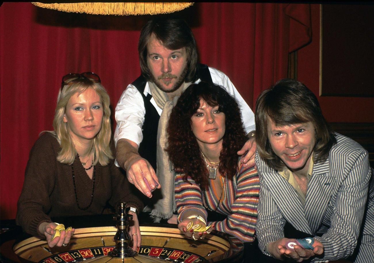 Swedish pop group Abba (L-R) Agnetha Faltskog, Benny Andersson, Anni-Frid Lyngstad and Bjorn Ulvaeus, play roulette during a visit to London in 1974 in London, England.