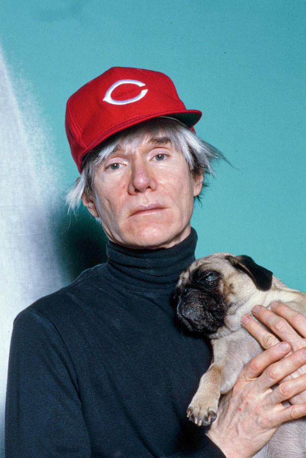 Andy Warhol with Brigid Berlin's Pug at the Factory, 1985