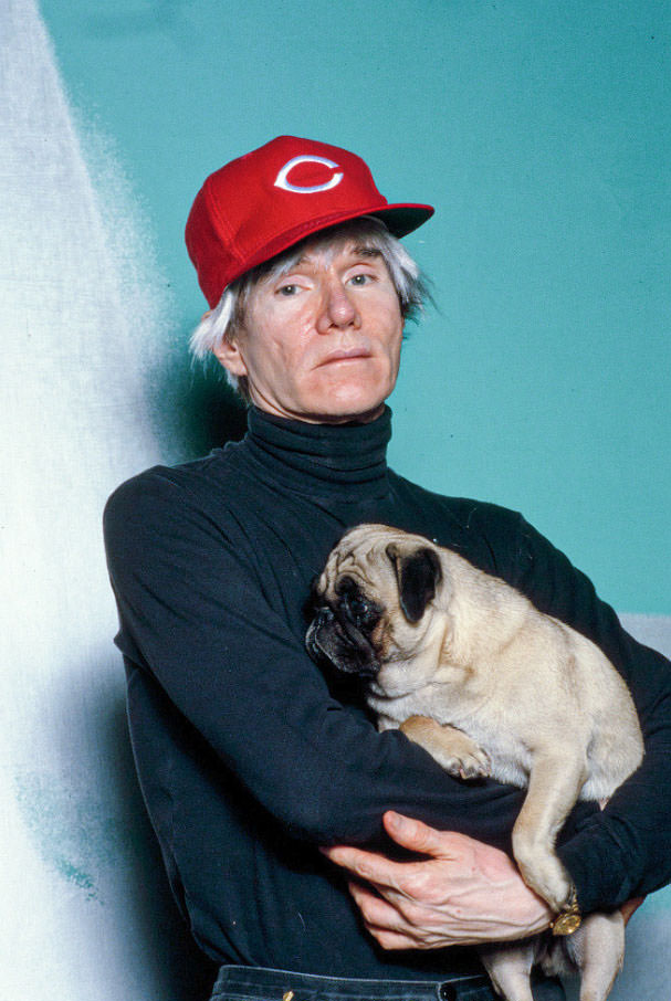 Andy Warhol with Brigid Berlin's Pug at the Factory, 1985