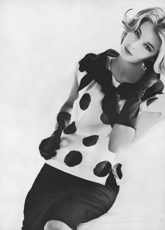 Anne de Zogheb in silk overblouse of black on white coindots and black triangle scarf around the neck by Vera, Vogue, January 15, 1962