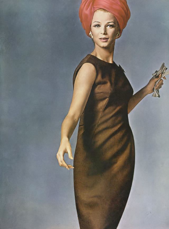 Anne de Zogheb in sleeveless brown linen skimmer, half-belted in back, by Mollie Parnis, earrings by Schlumberger of Tiffany's, Vogue, May 1, 1962