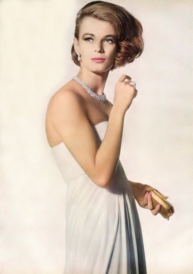 Anne de Zogheb in full-length white silk jersey with drapery gathered from lifted waistline flowing into small train in back, by Grès, coiffure by Guillaume, Vogue, November 1, 1961