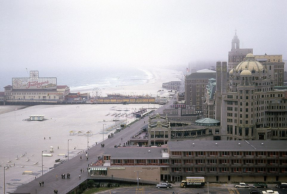 A shot showing an overview of the Atlantic City Boardwalk and the Steel Pier. On the pier, a huge ad can be seen for Fralinger's salt water taffy - a sweet treat