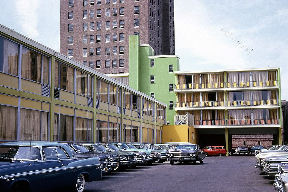 A glamorous array of large cars in the parking lot of the Colony Motel in 1962