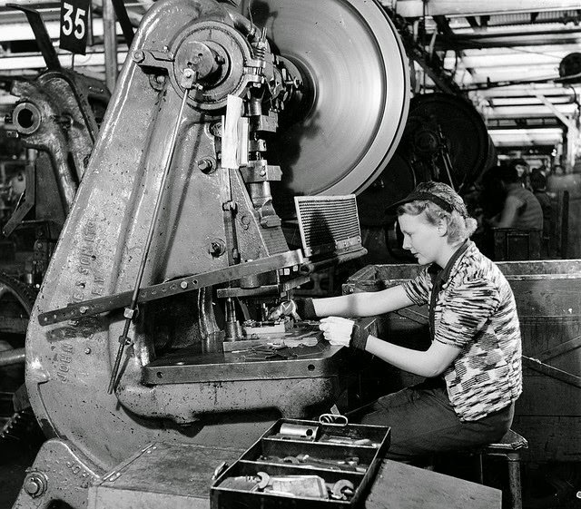 A woman working at a machine making parts for ribs of Beaufort bombers in a munitions factory in South Australia.