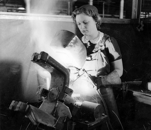 A young woman arc welding part of an anti-tank gun in a munitions factory in South Australia.