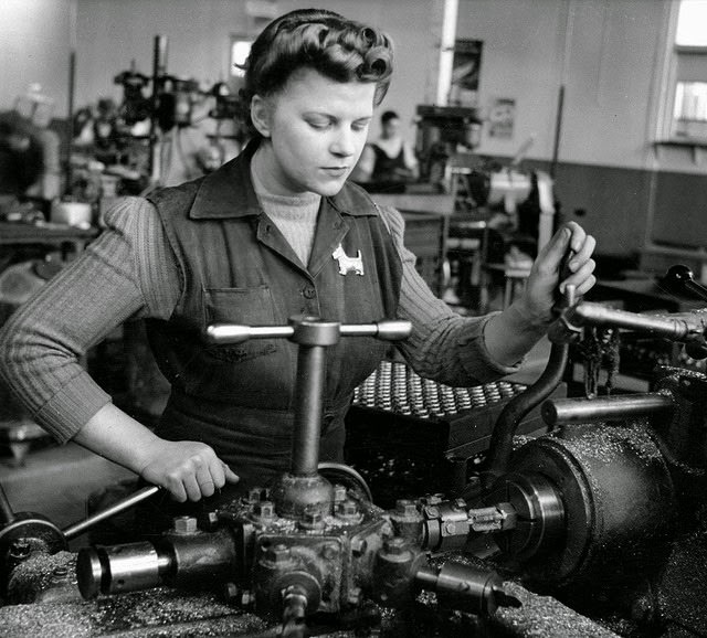 A young woman making brass fittings for military tanks.