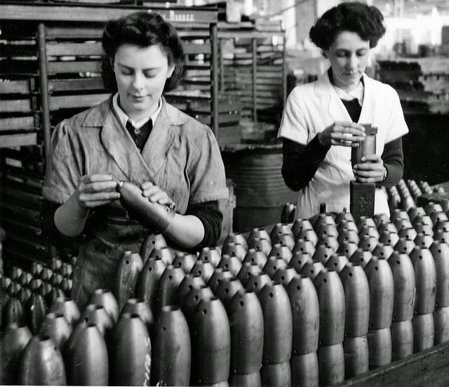 Yound women inspecting bomb bodies for RAAF practice bombs.