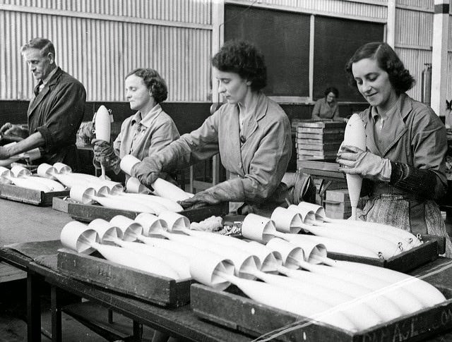 Inspecting RAAF practice bombs before removal to an explosives filling factory in South Australia.