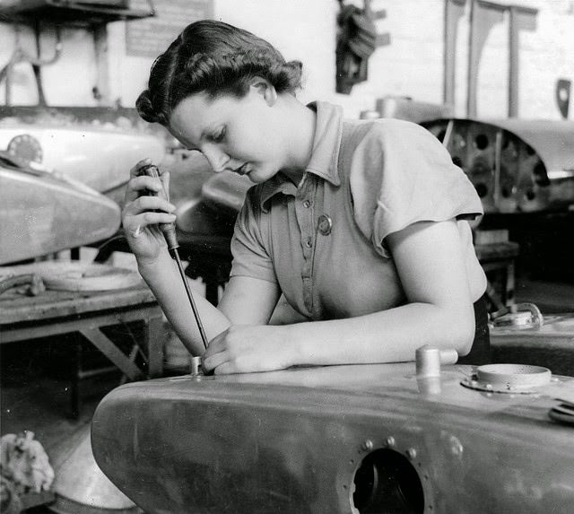 A young woman assembling an oil tank for a Beaufort bomber in a munitions factory in South Australia.