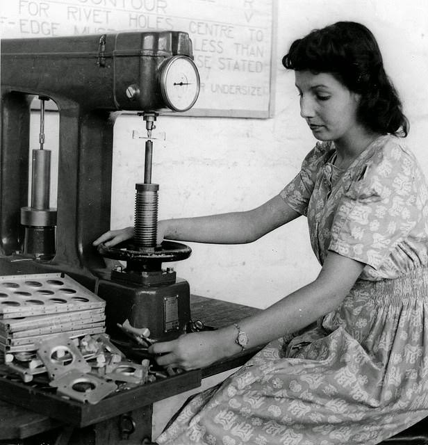 A young woman testing parts for hardness at a munitions factory in South Australia.