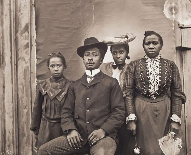James J. and Jennie Bradley Johnson Family. James J. Johnson, of Nipmuc, Narragansett, and African American descent, and Jennie Bradley Johnson, a migrant from Charleston, South Carolina, pose with their daughters Jennie and May.