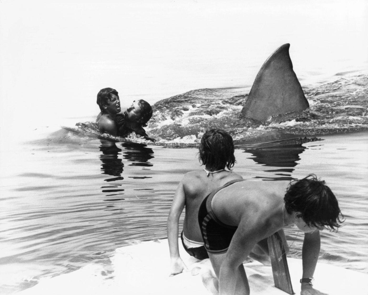 Boys attempt to escape the shark in a scene from the film 'Jaws', 1975.