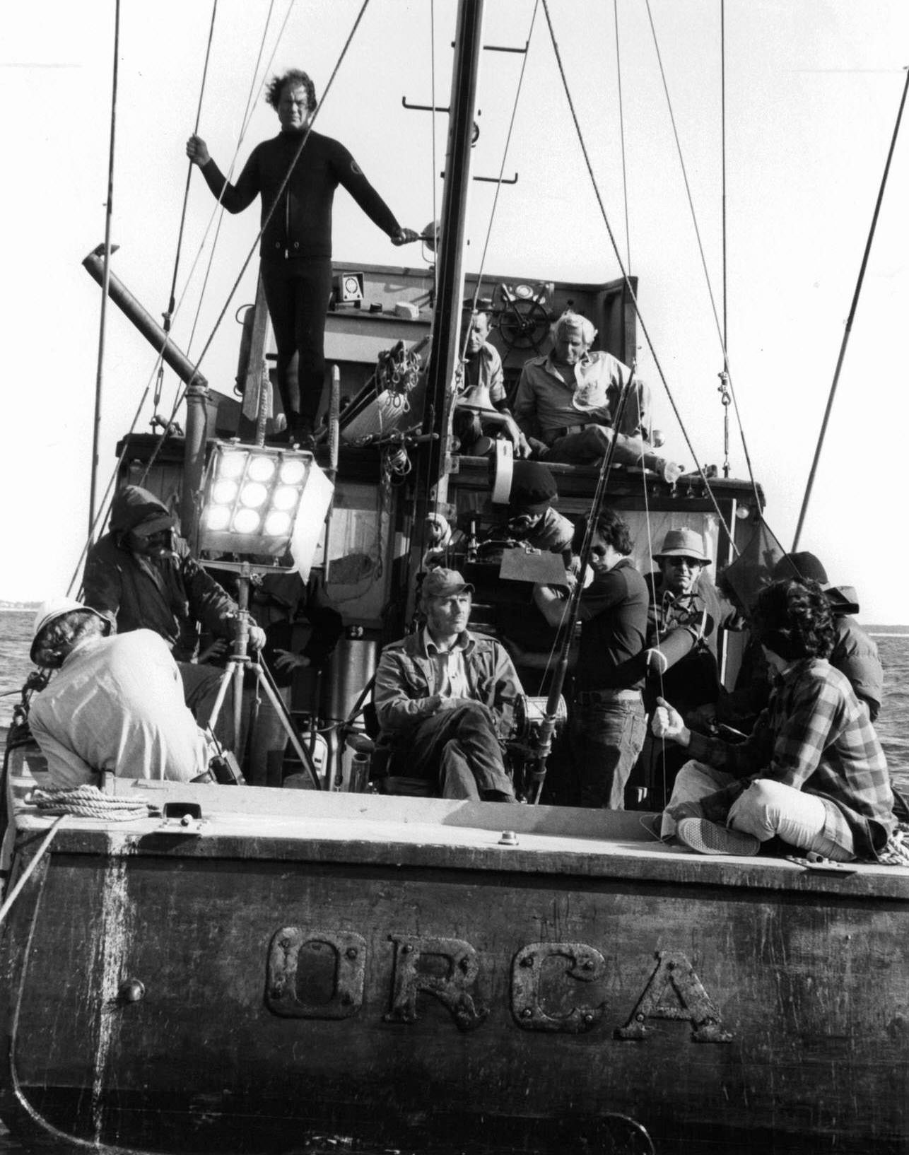 Roy Scheider on top deck as crew set up to film a scene from the film 'Jaws', 1975.