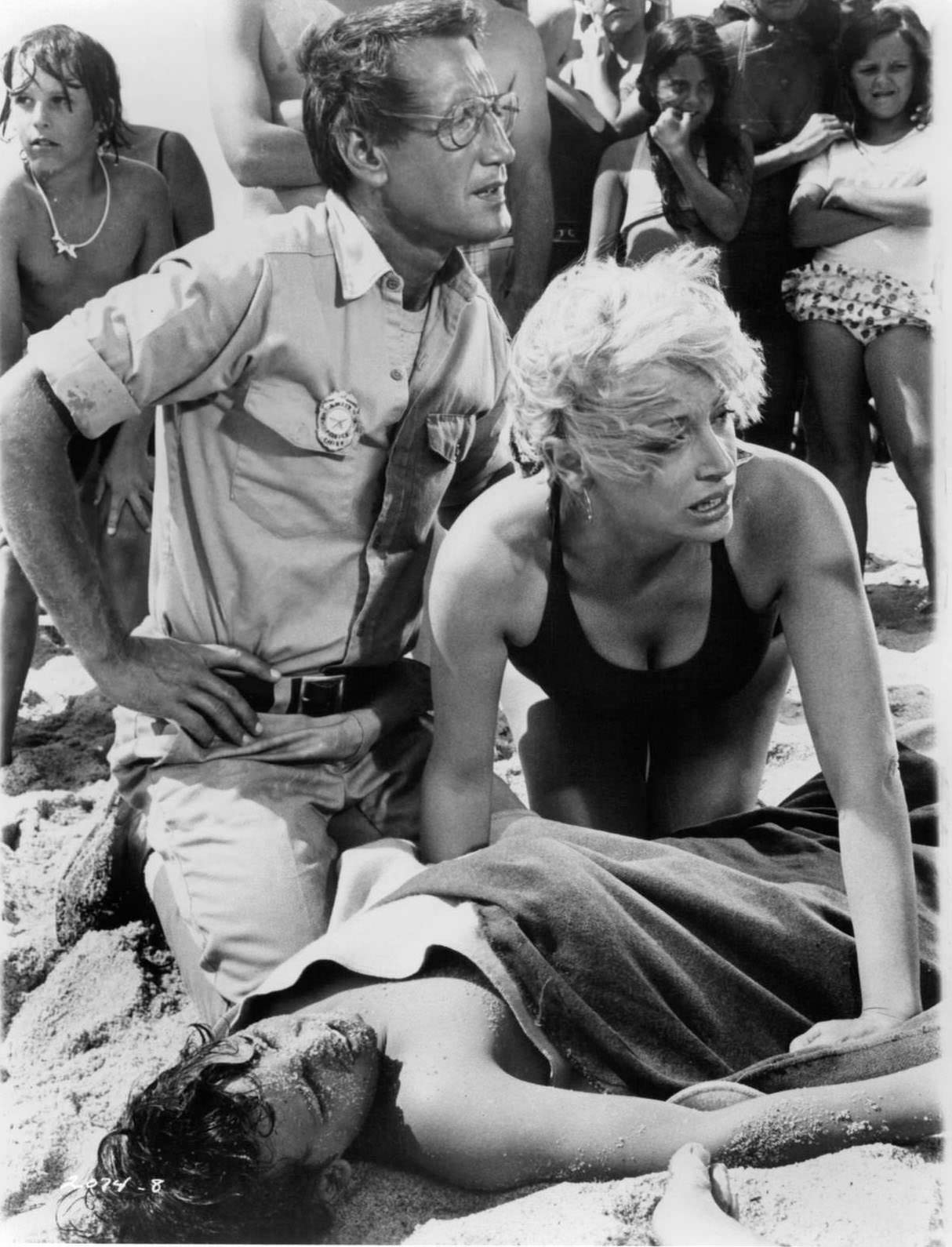 Roy Scheider and Lorraine Gary huddle anxiously over their son Chris Rebello in a scene from the film 'Jaws', 1975.