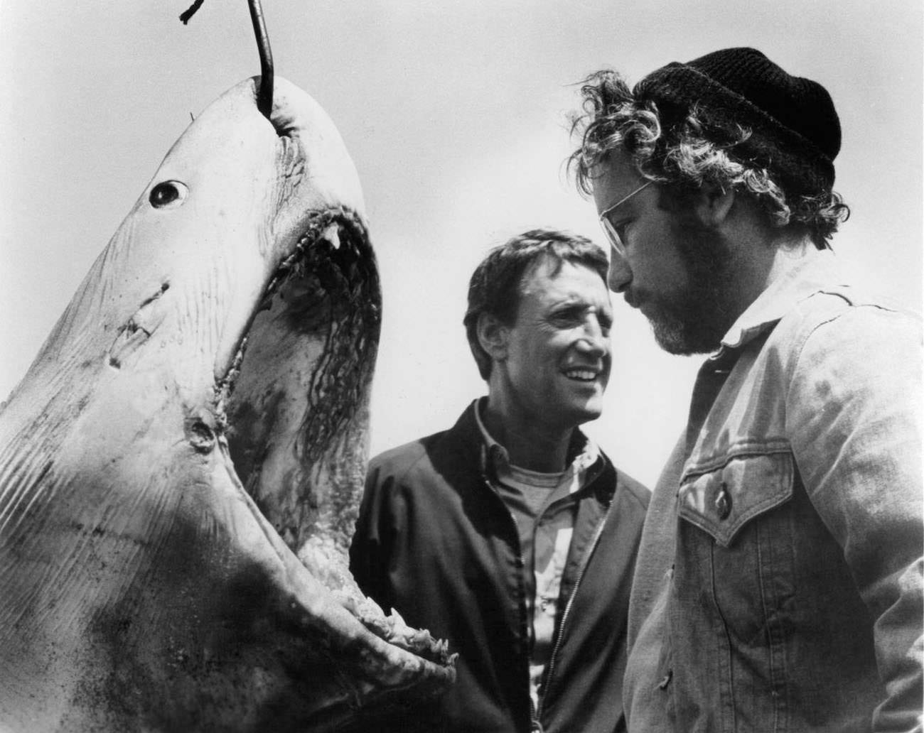 Roy Scheider and Richard Dreyfuss stand next to a giant man eating Great White Shark with a hook piercing through it in a scene from the film 'Jaws', 1975.