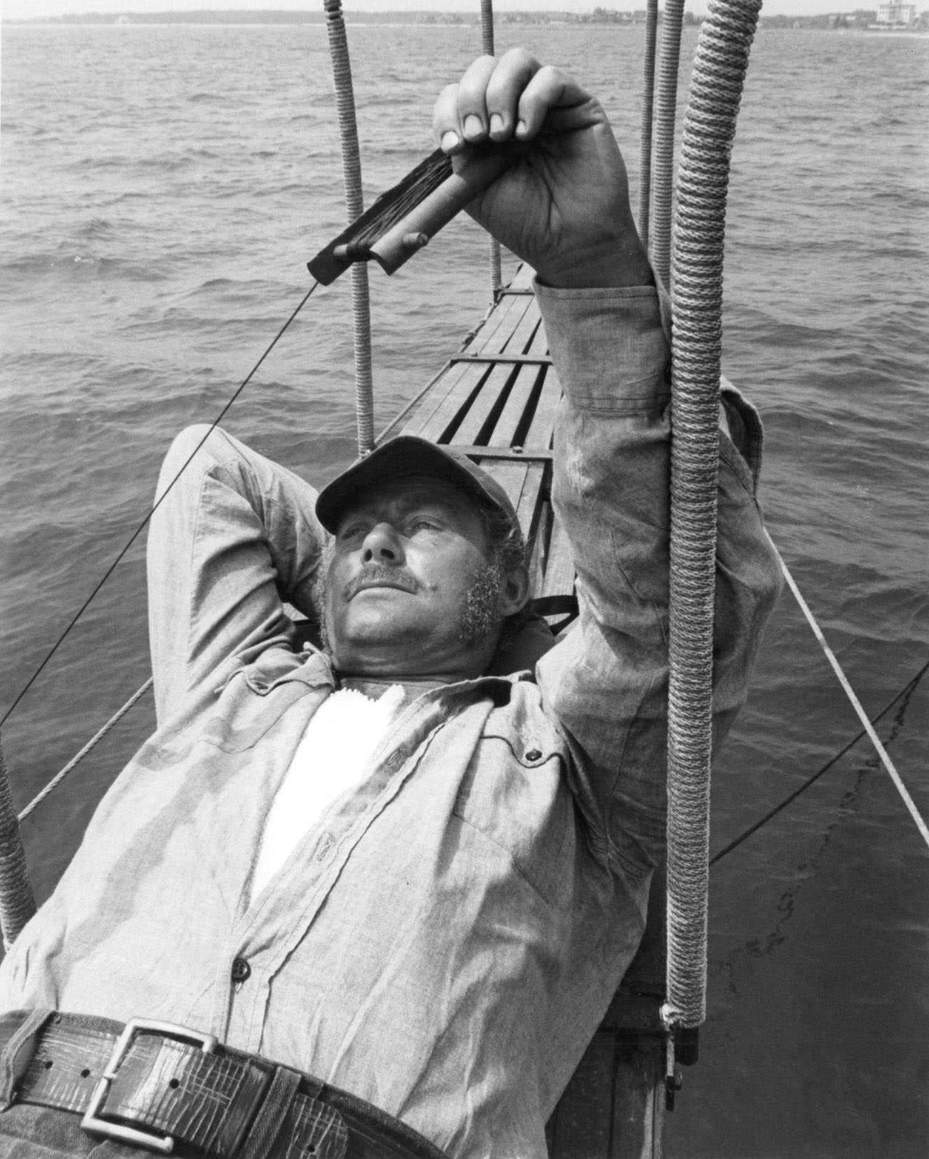 Robert Shaw lying down in boat in a scene from the film 'Jaws', 1975.