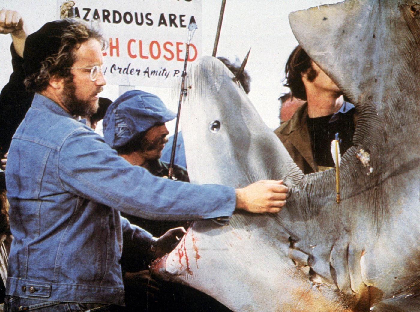 American actor Richard Dreyfuss inspects the mouth of a dead Great White shark in a still from director Steven Spielberg's film, 'Jaws,' 1975.