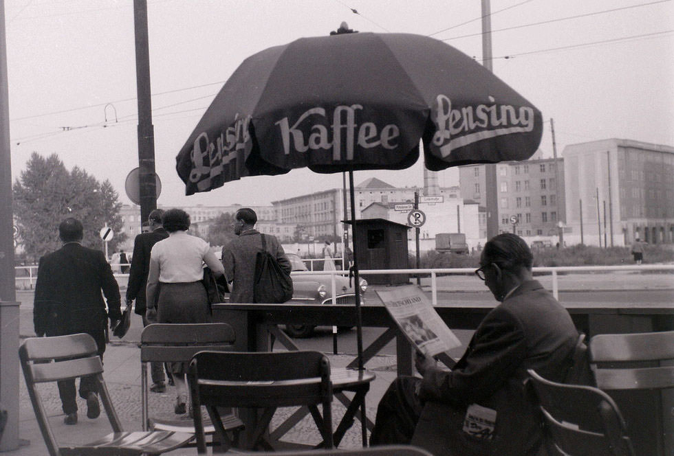 This cafe at Potsdamer Platz was just inside West Berlin, with the pavement in the West and the road in the East. The man is reading NEUES DEUTSCHLAND, the communist East Berlin newspaper.