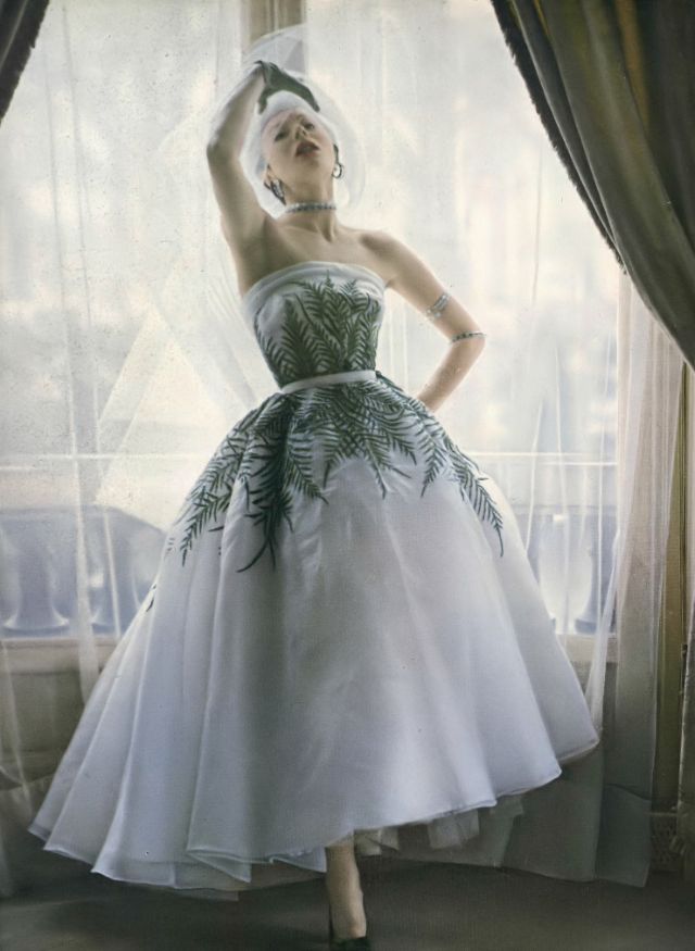 Bettina in gorgeous organdy dress embroidered with delicate traceries of ferns and sequins by Jacques Fath, 1950