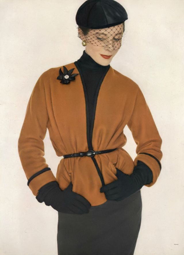 Bettina in rust box-cardigan jacket of brushed wool edged with black braid lined in black rayon jersey and completely reversible, skirt is banker's gray flannel, both at Bonwit Teller, 1950