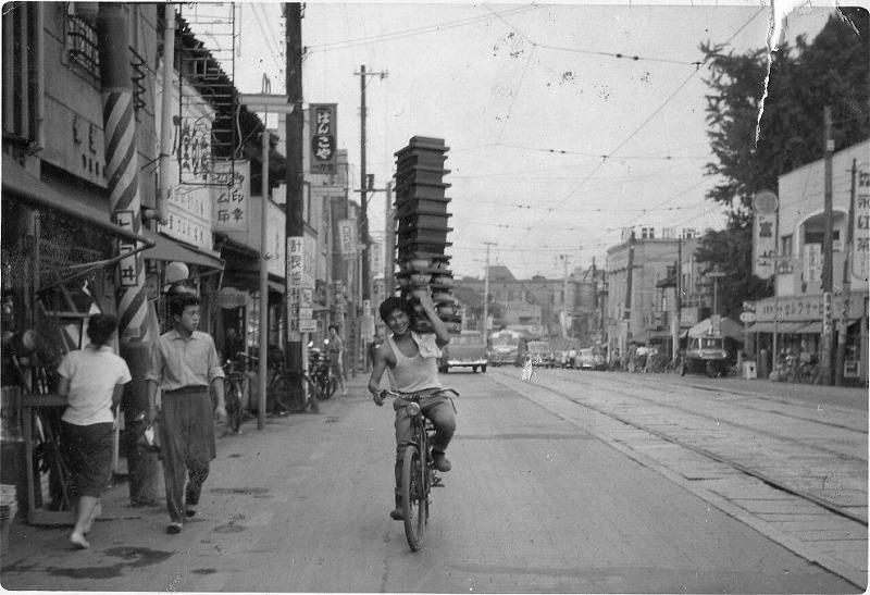 A young man delivering soba alond Meguro-dori in Tokyo.