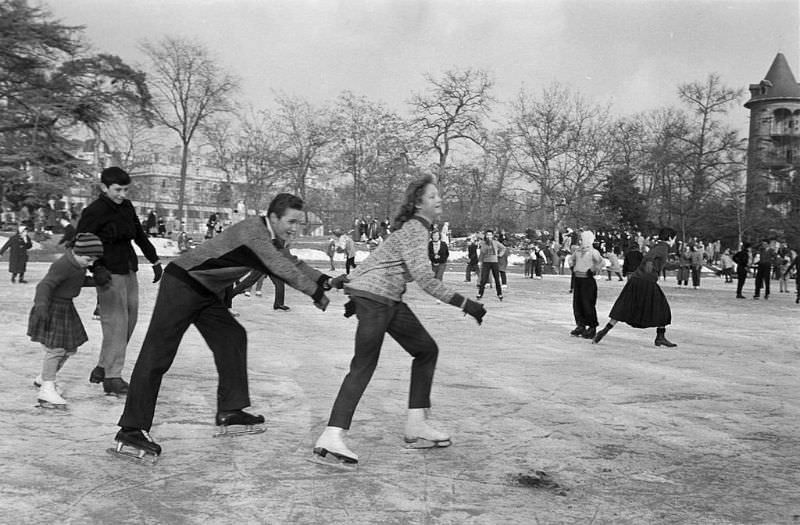 A young couple skating on the playground.