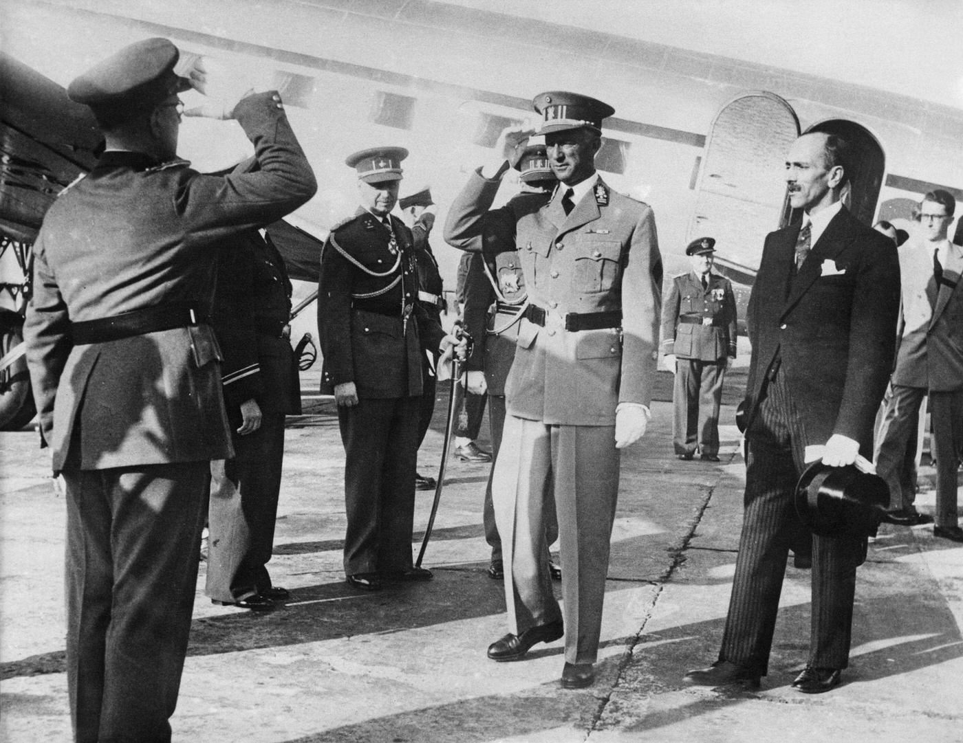 King Leopold III of Belgium is greeted on his arrival as he returns to Brussels from exile in Swizerland where he has spent the last six years, 22nd July 1950.
