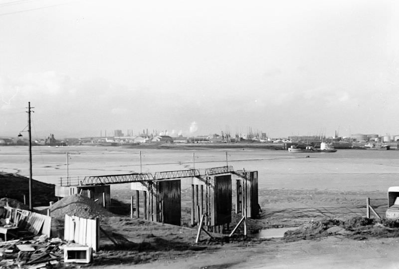 Low tide. Looking towards Cardiff docks before the barrage. A dredger is at work near Queen Alexandra dock, Cardiff, May 1973