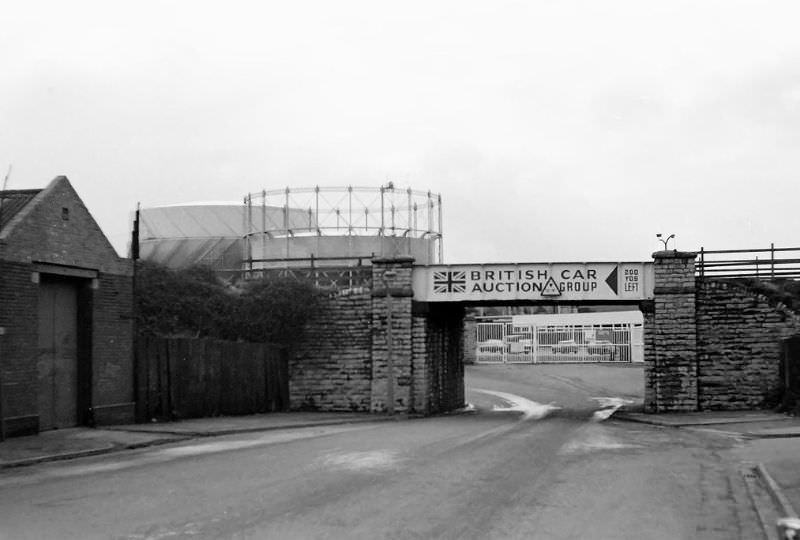 Looking west in Grangetown. This was the bridge that took the freight line down to the old oil terminal by the river Ely. The bridge has gone now and the view ahead dominated by IKEA, Cardiff, December 1974