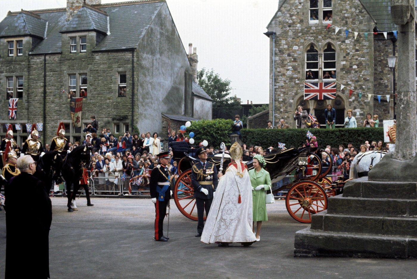 Queen Elizabeth II being greeted by the Bishop of Llandaff, the Rt Rev John Worthington Poole-Hughes, as she arrives with the Duke of Edinburgh at Llandaff Cathedral, Cardiff