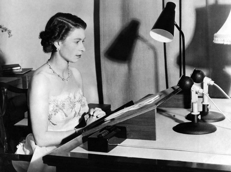 Queen Elizabeth II makes her annual Christmas Day broadcast from a recording studio inside Auckland, New Zealand's Government House, on December 25, 1950.