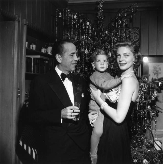Lauren Bacall and Humphrey Bogart celebrate Christmas Eve with their son, Stephen Bogart, in their home in California, 1951.