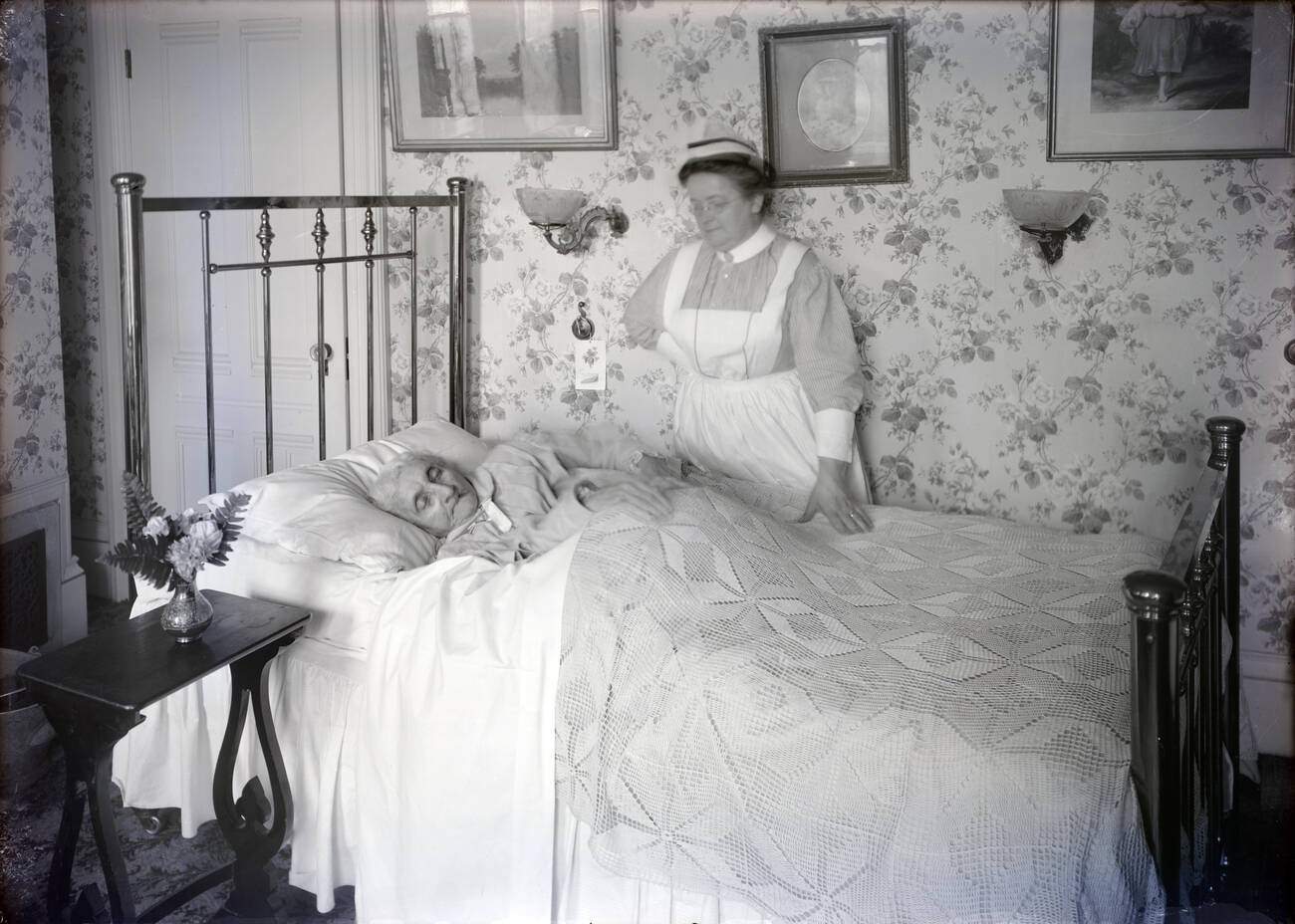 A sick elderly woman with a nurse.