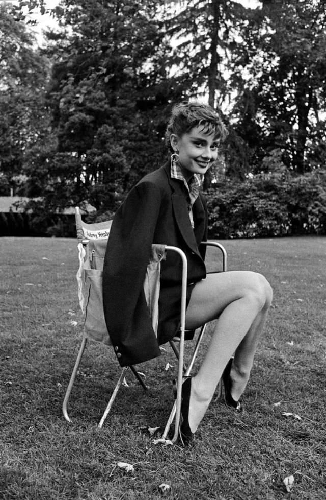 Audrey Hepburn wearing Humphrey Bogart's jacket takes a break on the set of ‘Sabrina’, 1954