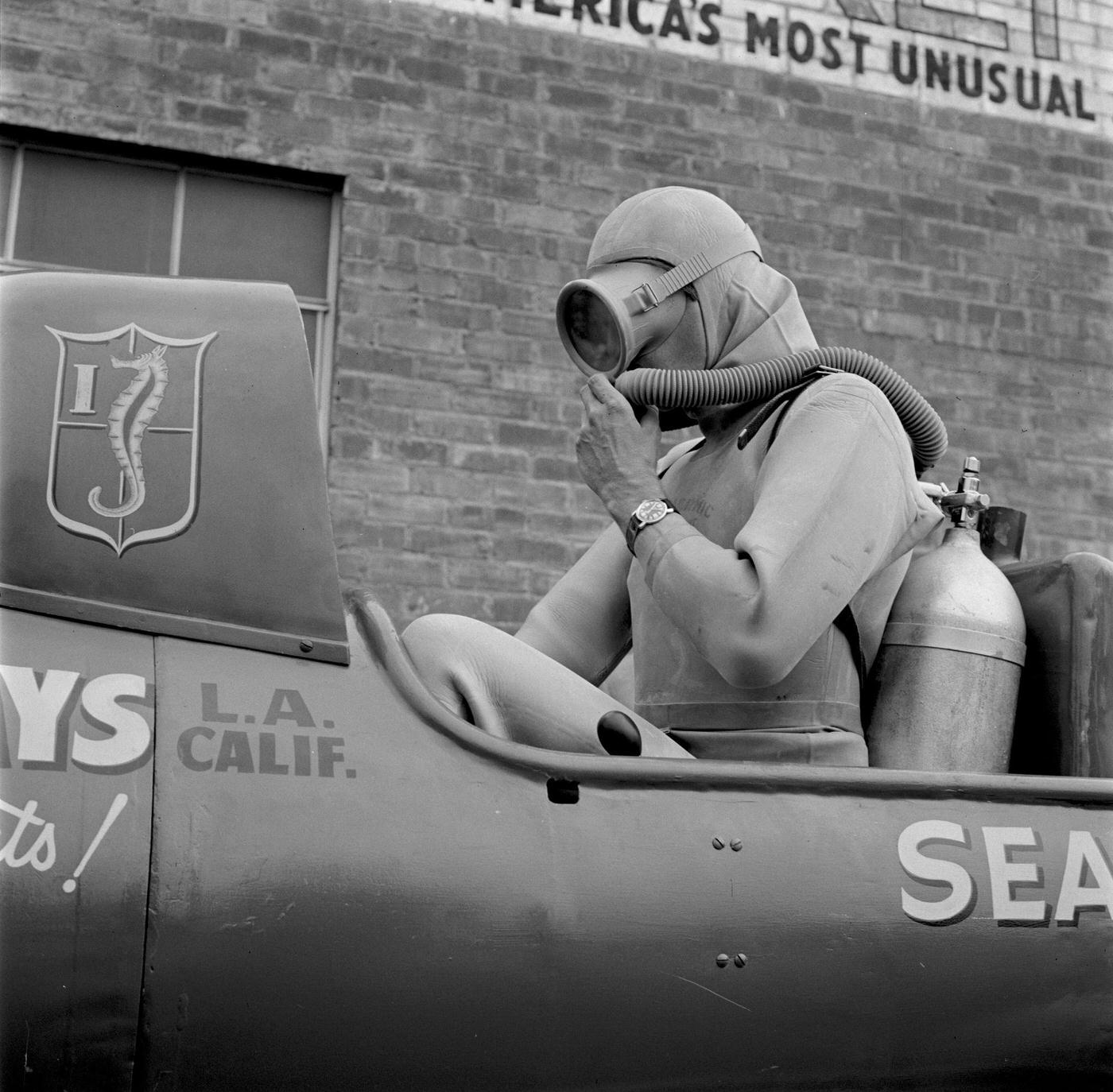 Two-Man Submarine named Sea Horse I with scuba diver on trailer outside of Healthways, America's Most Unusual Sporting Products.