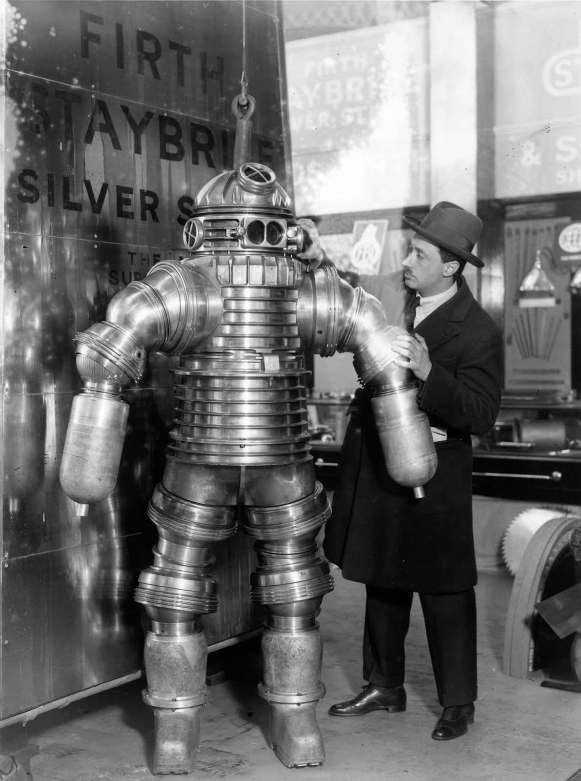 Inventor J. S. Peress explains the workings of his new rustless diving suit, made of Staybrite Silver Steel, at the Olympia Shipping Exhibition in London.