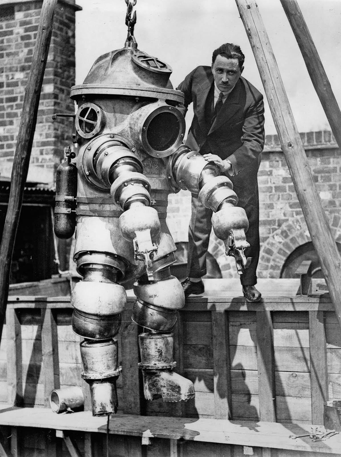 J.S. Peress, the inventor of a new armored diving suit, gets his device ready for tests in a tank at Weybridge, United Kingdom. 1930.