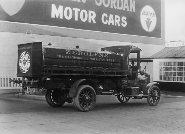 Standard Oil Company Red Crown Gasoline and "Zerolene" Federal brand refueling truck parked at a San Francisco Standard Oil Co. gas station. Large billboard in the background advertising "Jordan Motor Cars", 1918