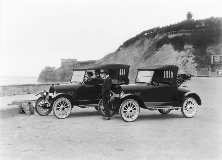Briscoe Motor Cars pictured along the end of the Great Highway in San Francisco, California. The historic Cliff House and Sutro Heights are visible in the background, 1919