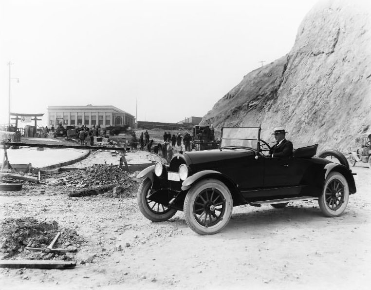 A 1922 "Dealer" license plate car at the historic San Francisco Cliff House with extensive construction taking place along the roadway and sidewalk, 1922