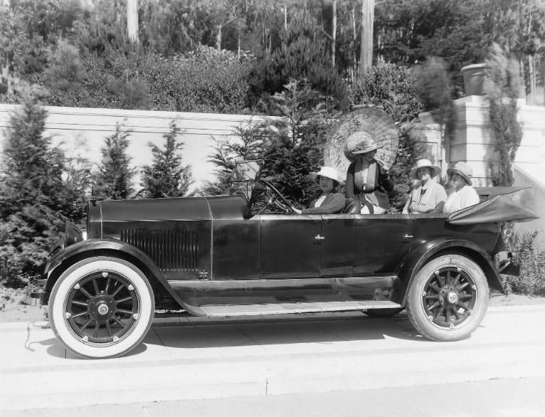 A carload of well-dressed ladies pictured in a Cole Motor Car convertible in San Francisco's prestigious St. Francis Woods neighborhood, San Francisco, California, 1920s