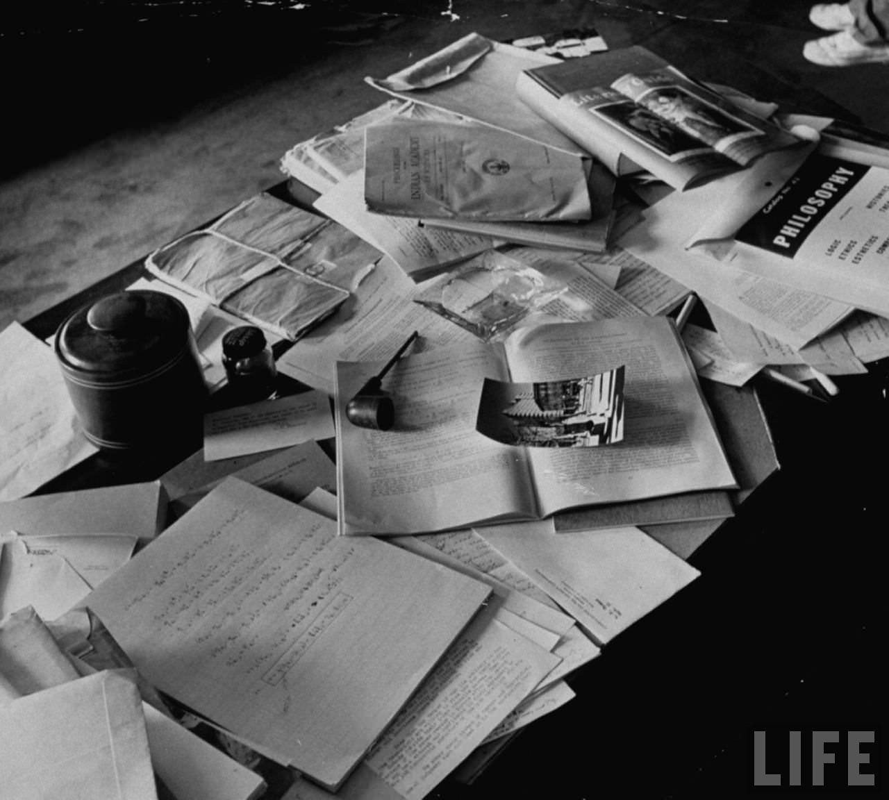A poignant snapshot of Albert Einstein's personal items and papers, including his pipe and ashtray, captured in his Princeton office on April 18, 1955, after his death.