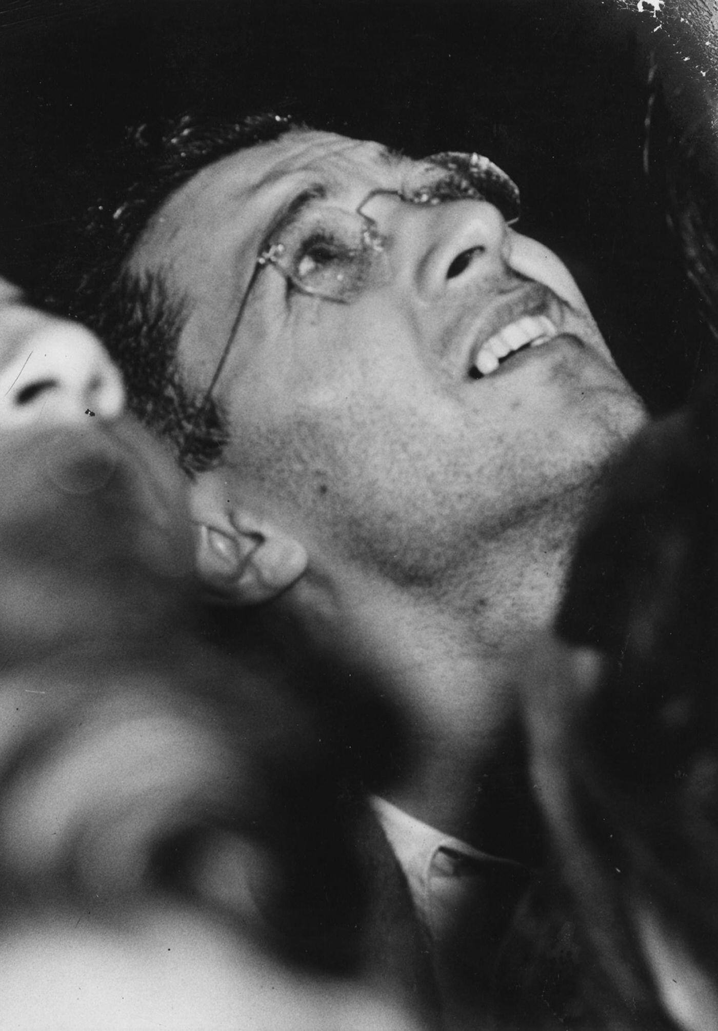 Close-up of a man as he looks up at the Empire State Building